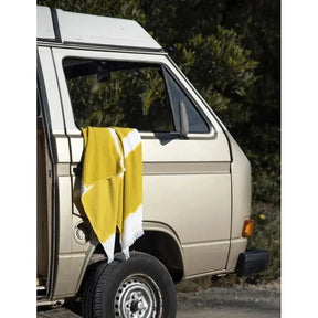 Graccioza Bricini Fancy Beach Towel in Mustard hanging out of a vans window