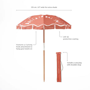 Sunnylife Beach Umbrella Baciato Dal Sole. Features a 4 prong hook attachment to hang your towels on. UPF 50 protection coating. Includes a carry bag with shoulder strap