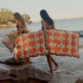 Two women carrying Sunnylife Vintage Lie On Royal Mansour