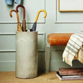 Pigeon and Poodle Rustic White Stoneware Maribo Umbrella Stand in a room with an umbrella