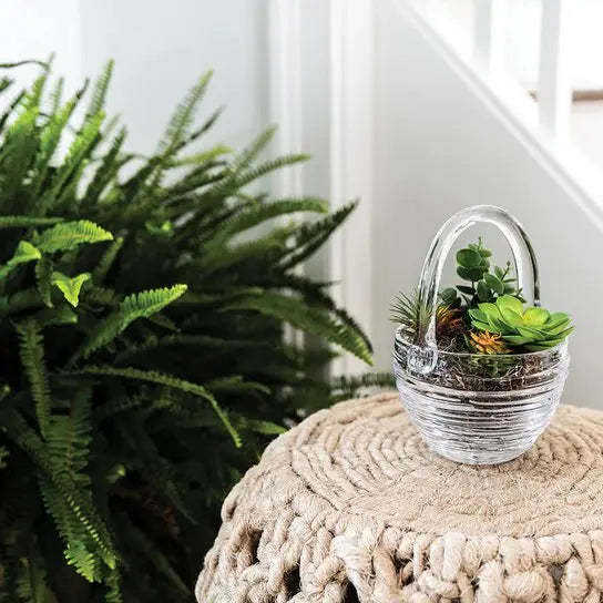 Simon Pearce Echo Lake Basket on a rope woven side table next to a plant in a room