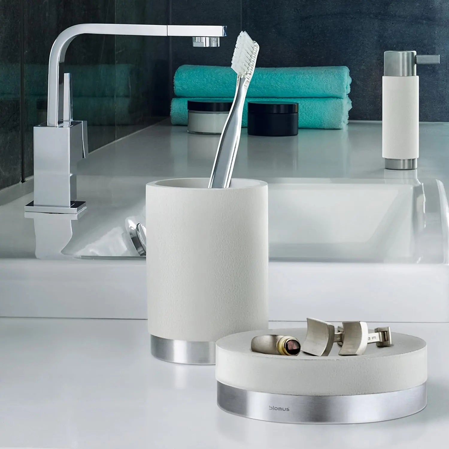 Blomus ARA Soap Dish in White by the sink with jewelry on top.