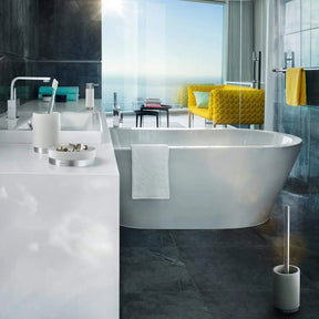 Blomus ARA Soap Dish in Moon Grey sitting on a bathroom vanity in a bathroom