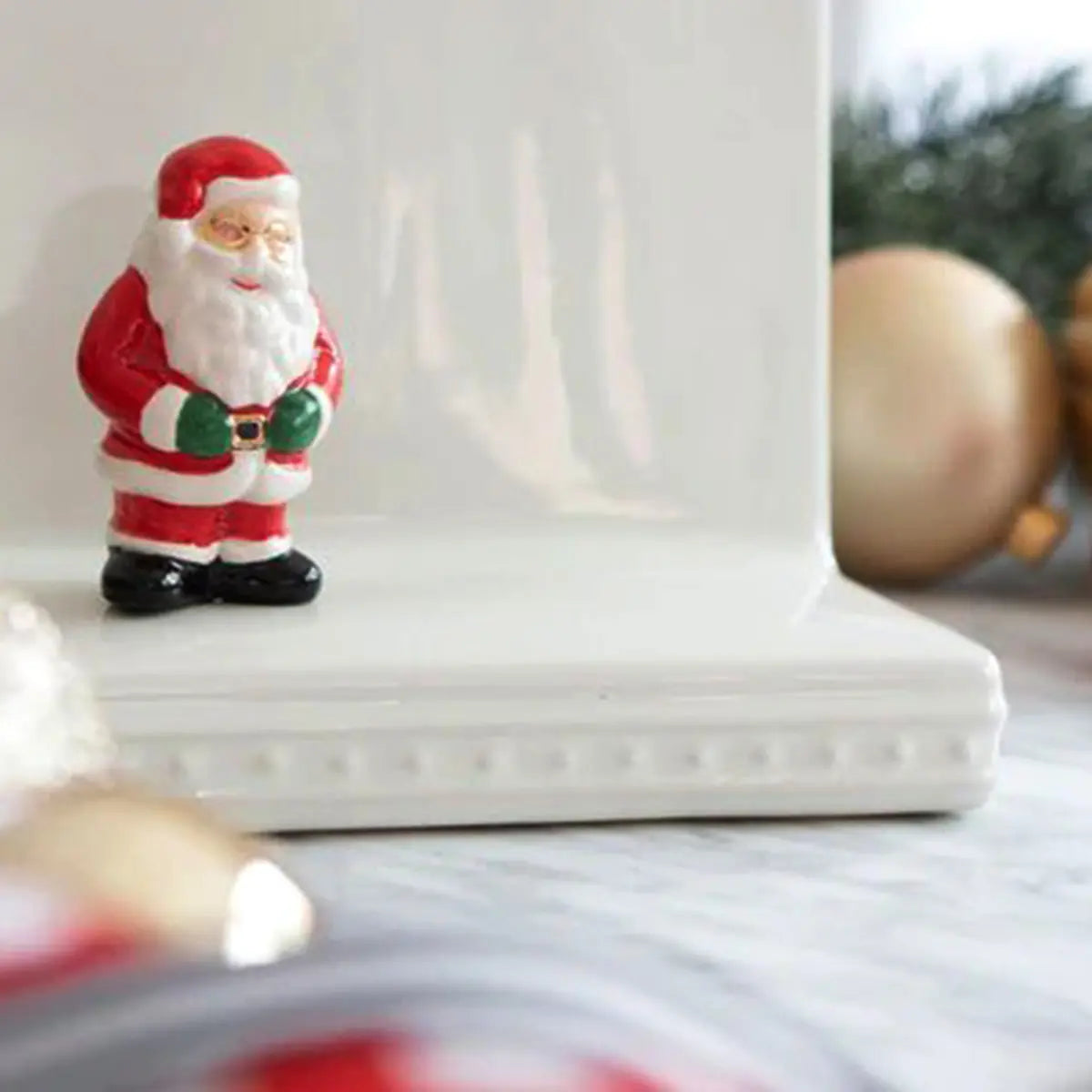 Nora Fleming Santa Claus Mini in a room on a napkin holder