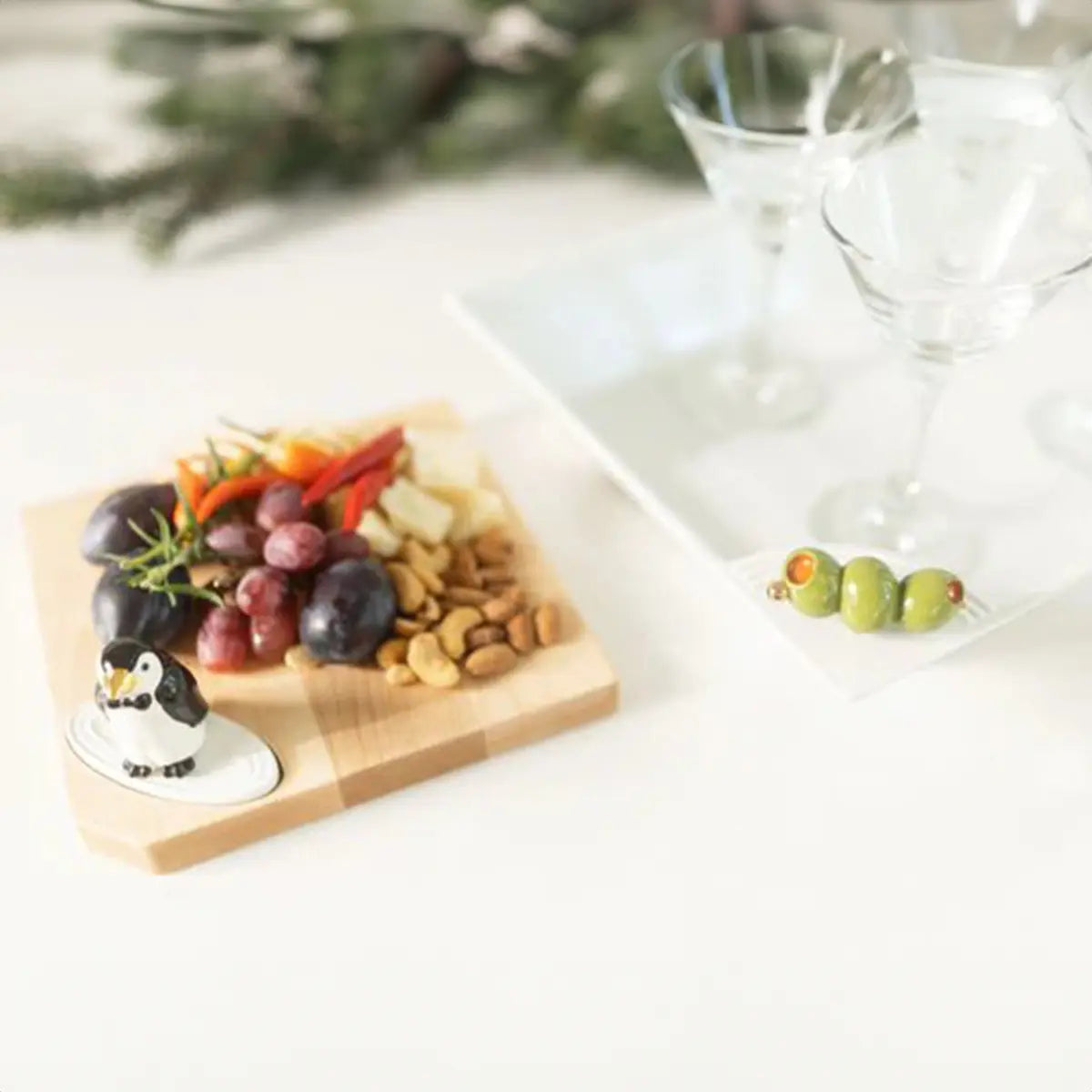 Nora Fleming Olive You So Much Olive Mini on a serving board with food