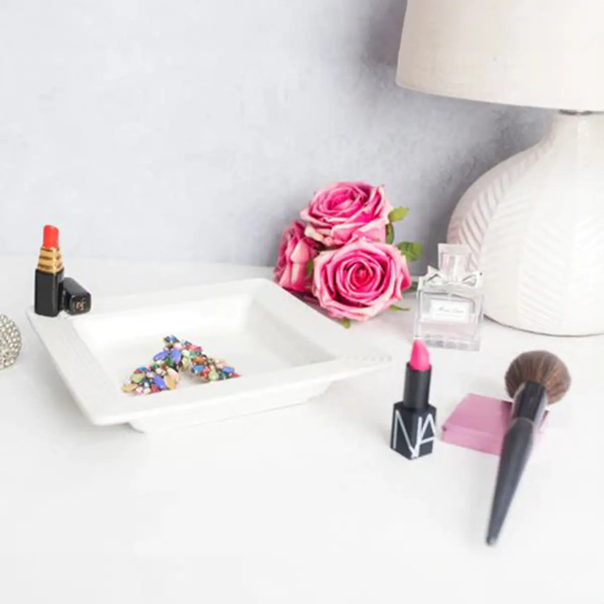Nora Fleming Hello Gorgeous Lipstick Mini with tray with flowers and table lamp in a room