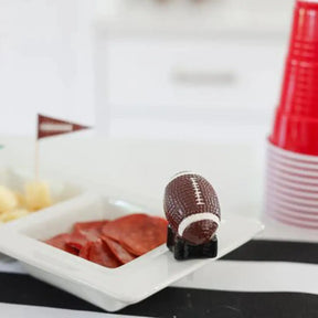 Nora Fleming Touchdown Football Mini on a tray with food in a room