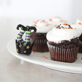Nora Fleming Pinstripes Round Server with chocolate cupcakes with orange and black sprinkles on top with a witch leg mini