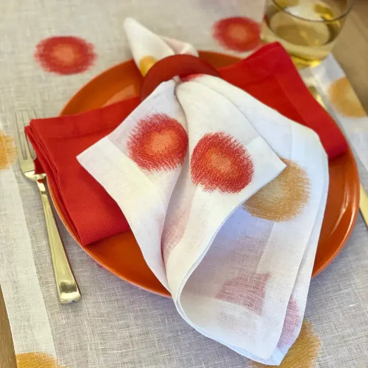 Bodrum Confetti Napkin in Red Marigold set on a plate 