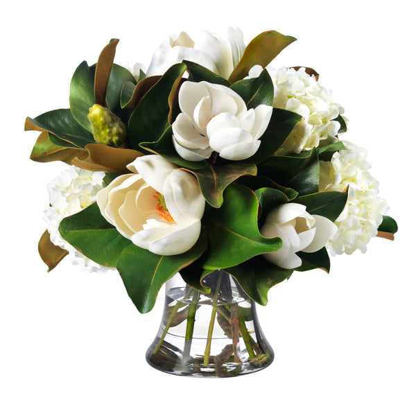 An image of Diane James Magnolias and hydrangeas in glass vase - 20"d x 18"h