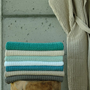 Abyss Pousada Towels in various colors in a room
