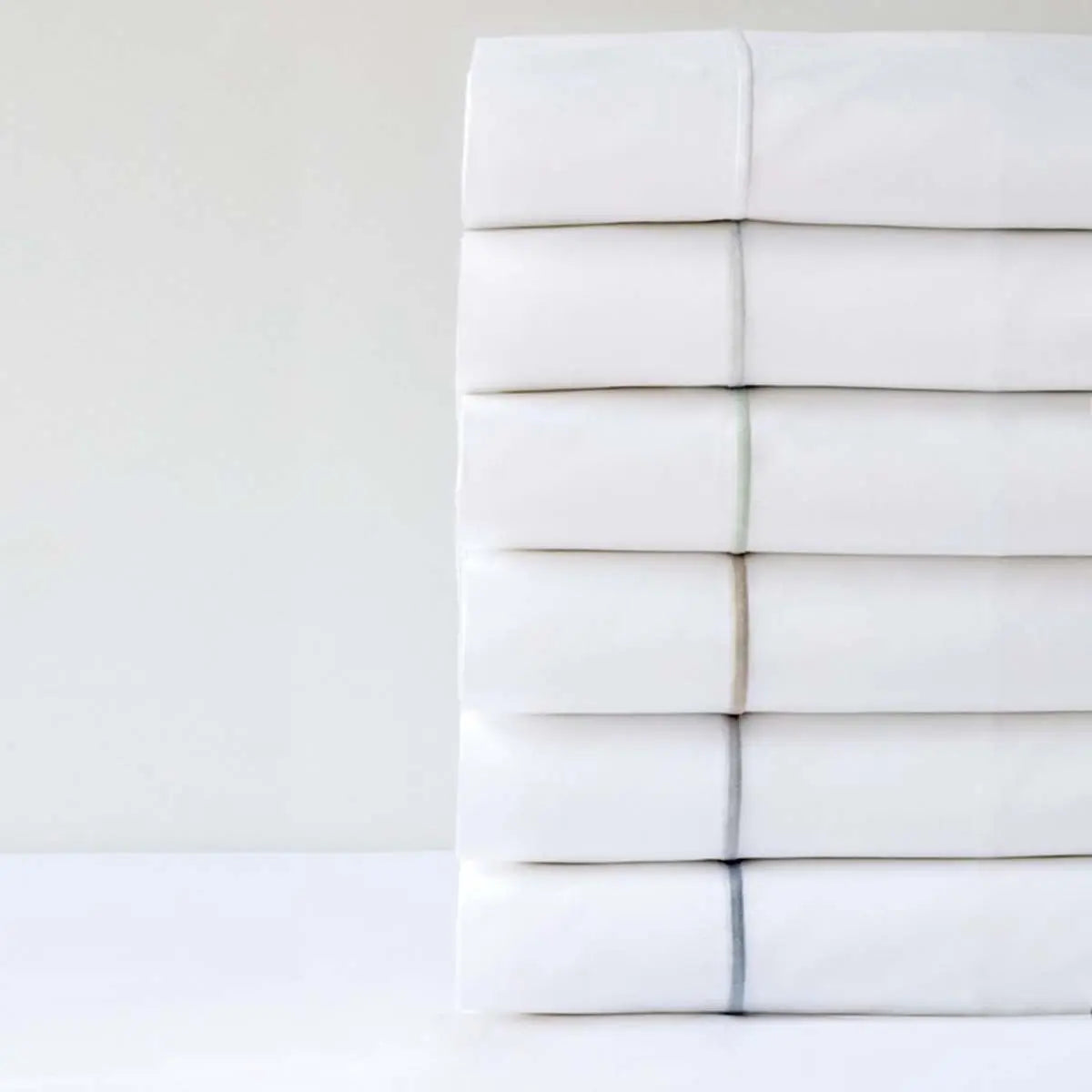 Bovi Classic Hotel Sheet Sets in Various colors, stacked together.