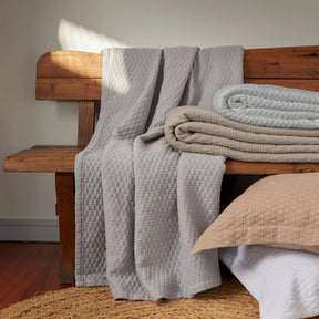 Bovi Simply Cotton Shams in various colors on a bench