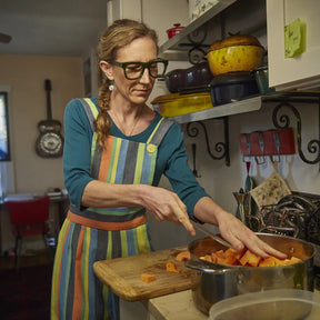 Woman wearing Caddis D28 Readers - Heritage Green in the kitchen