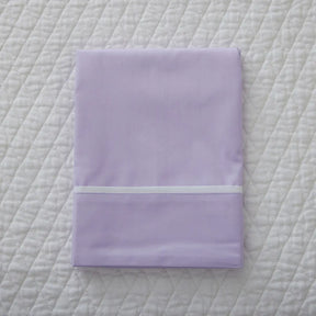 Gracious Home Bali Flat Sheet and Pillowcase in Lilla Lilac on a bed