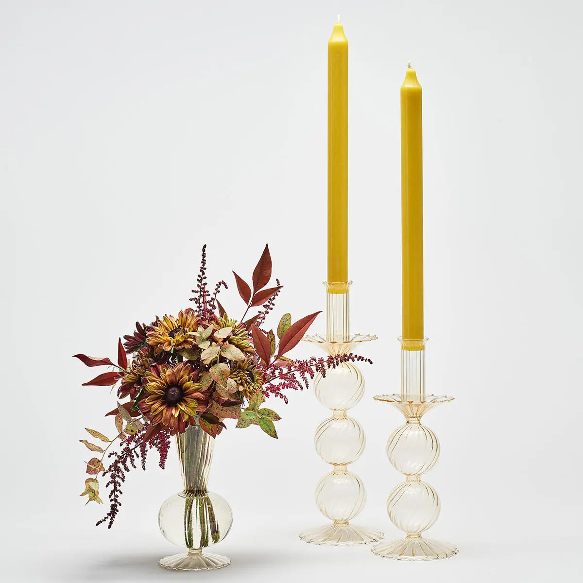 Kim Seybert Bella Champagne Candlesticks set with flowers and candles