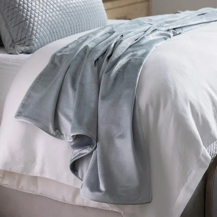 Lili Alessandra Milo Unquilted Throw Aquamarine Velvet draped on a bed in a room