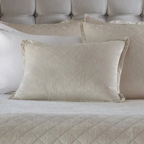 Lili Alessandra Chloe Diamond Quilted Pillow Collection in Ivory set on a bed