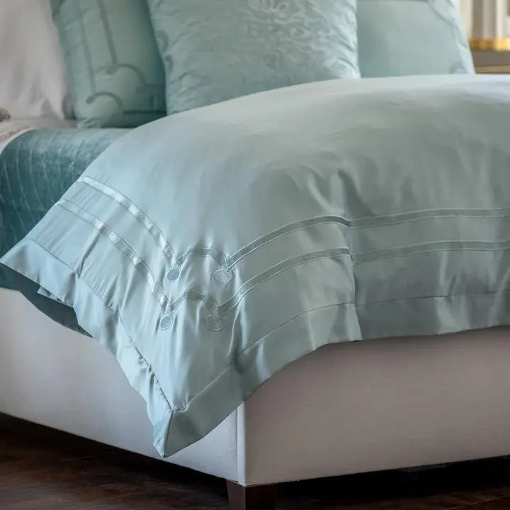 Lili Alessandra Vendome Duvet Cover in Sea Foam draped on a bed in a room