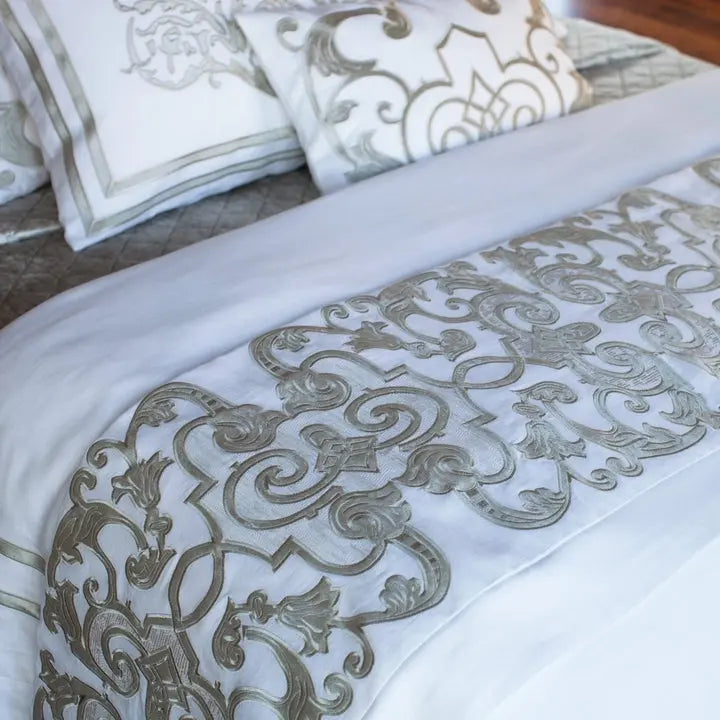 Lili Alessandra Mozart Throw in White Linen and Ice Silver Velvet draped on a bed in a room