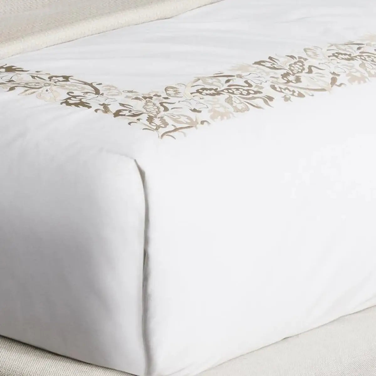 Sferra Saxon Duvet Cover in Champagne on a bed