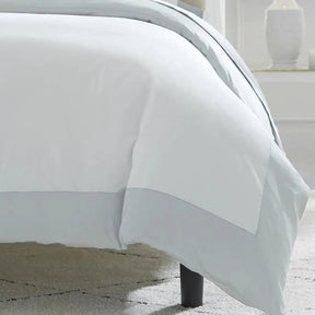 Sferra Casida Collection Duvet Cover in White/Lunar on a bed