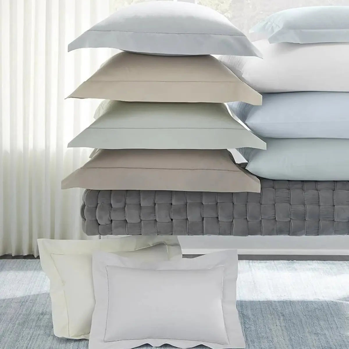 Sferra Celeste Shams Stacked on a bench in Various colors