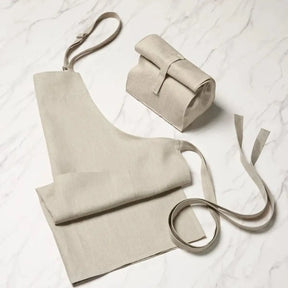 Sferra Cucina Apron in Natural Laid on the floor folded up and unfolded