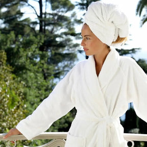 Woman wearing Yves Delorme Etoile Shawl collar Bath robe in Blanc outdoors
