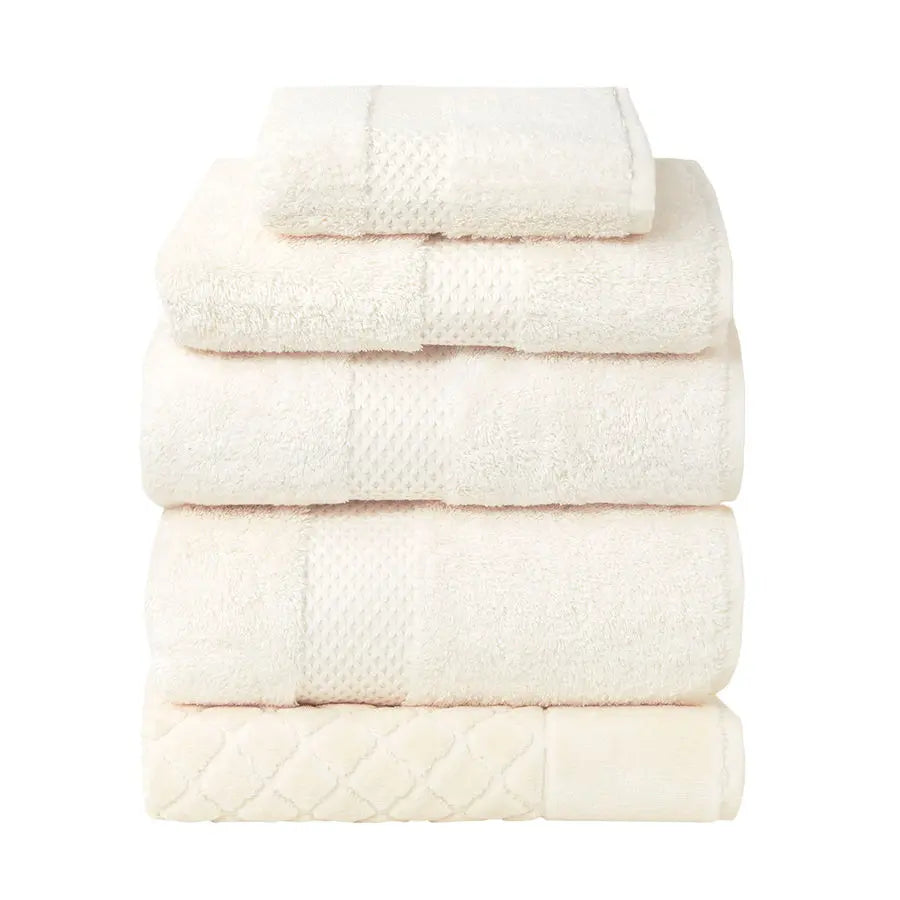 Yves Delorme Etoile Bath Towels and Rug Collection in Nacre color stacked together