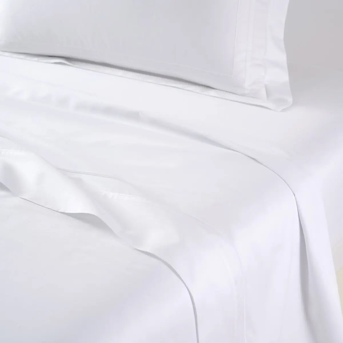Yves Delorme Lutece Flat Sheet in Blanc on a bed