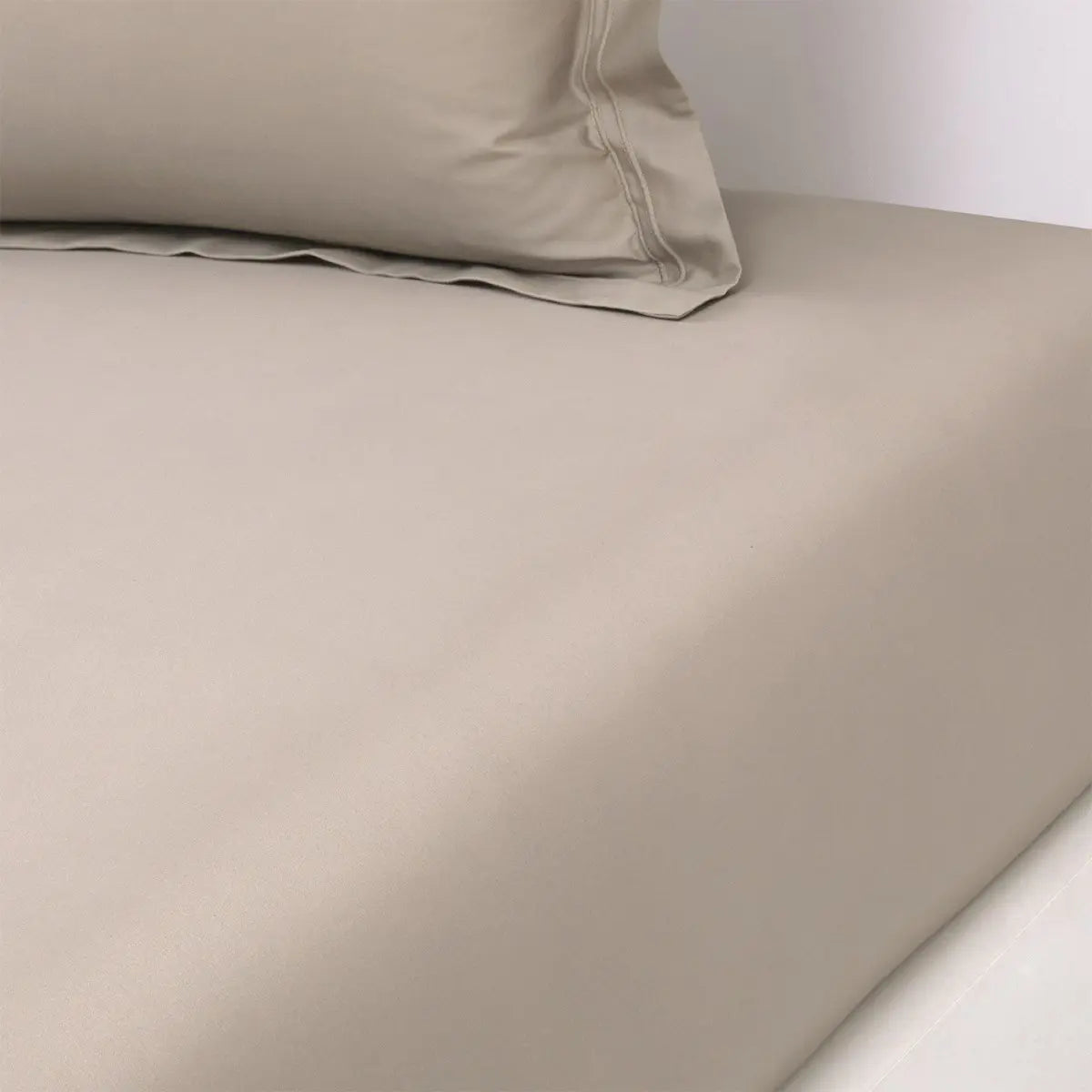 Yves Delorme Triomphe Fitted Sheet in Pierre on a bed