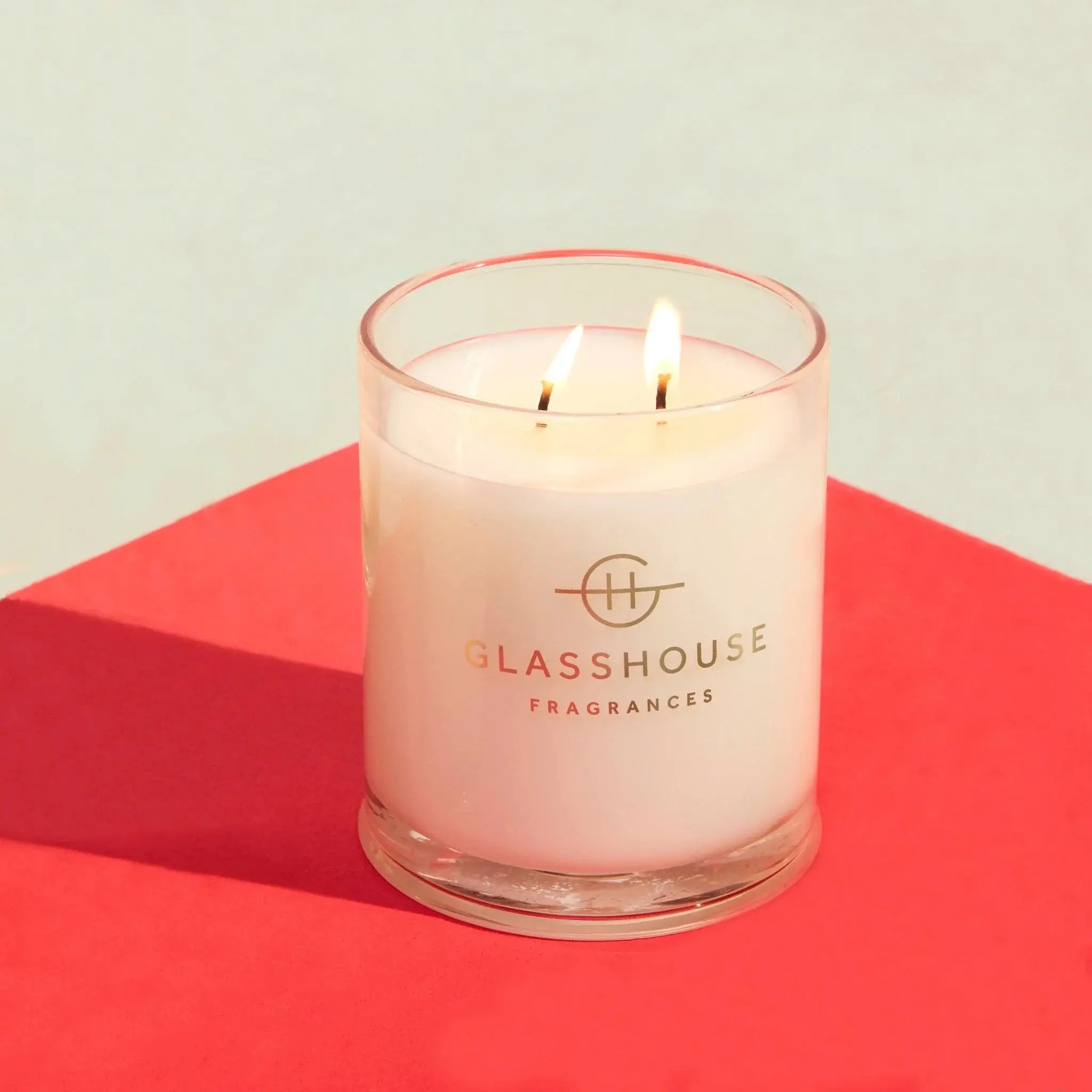 Glasshouse 13.4 ounce Candle lit in a room