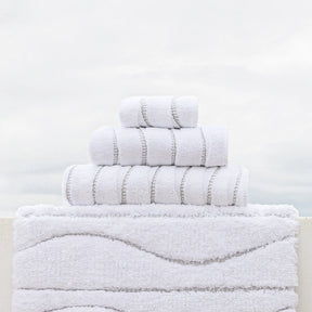 Graccioza Opera Bath Rug and towels set outside on a ledge