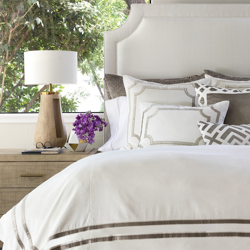 Image of bed made with Lili Alessandra Soho Bedding set white and Pewter