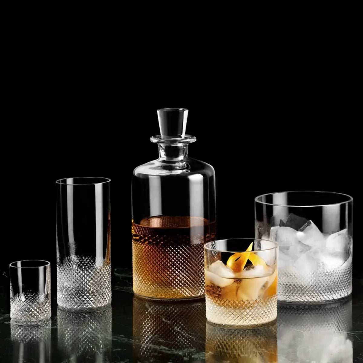 Richard Brendon Diamond Highball glass in a black room with other glassware