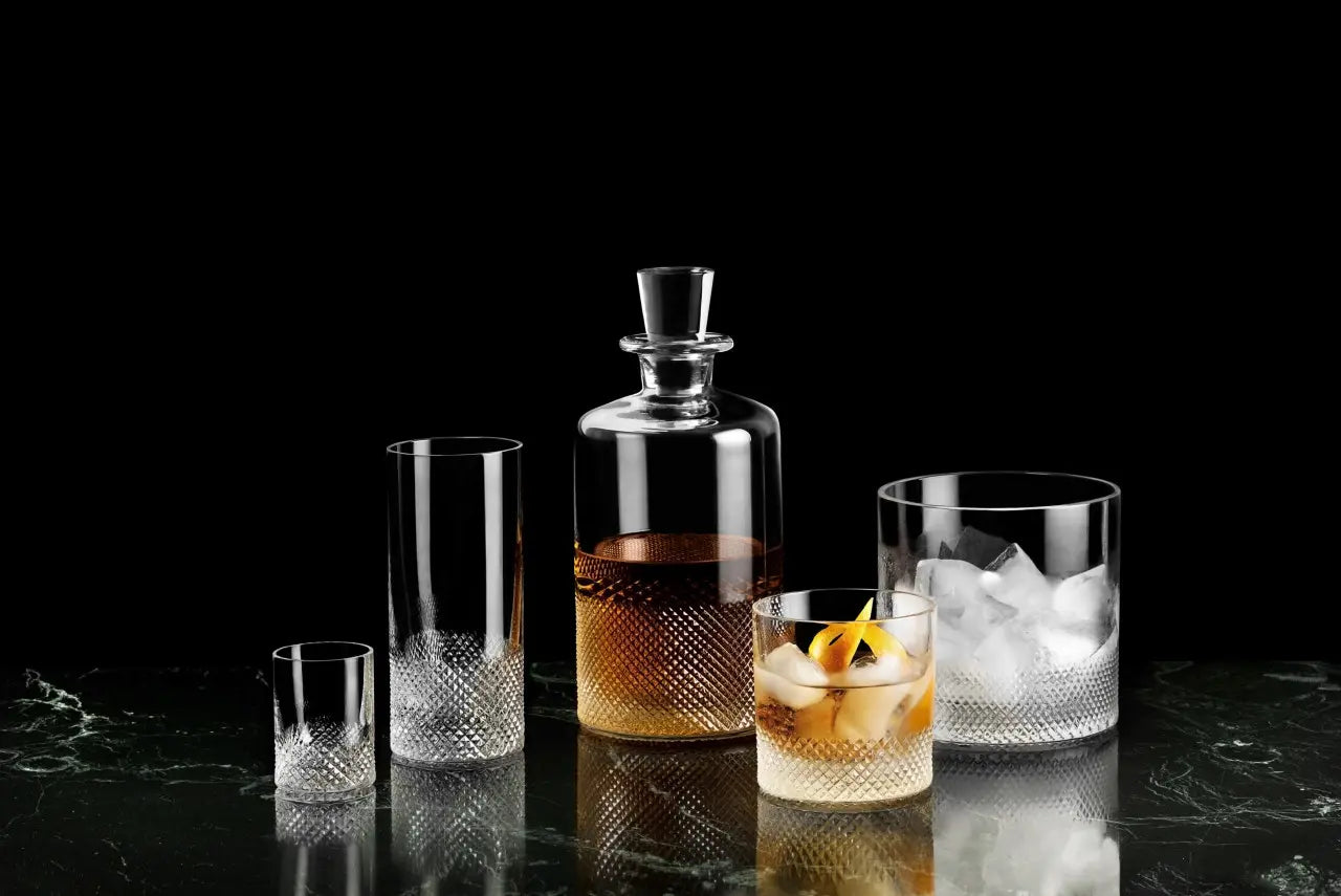 Richard Brendon Diamond Ice Bucket in a black room with other glassware