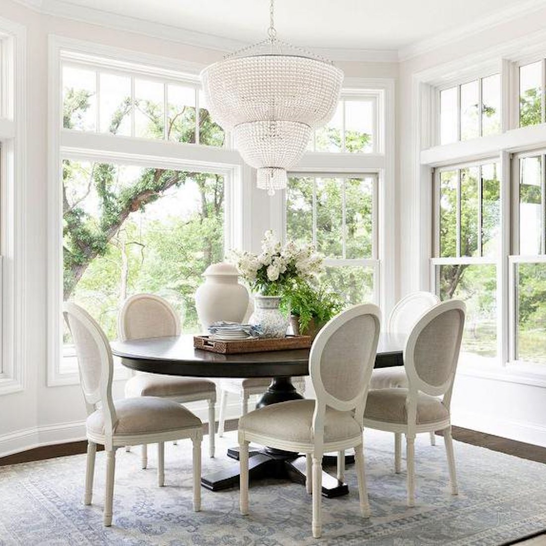 dining room setting with large chandelier overhead